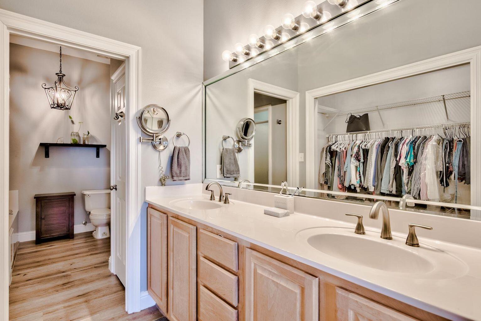 4507 Furling Lane, Unit 302 Destin, FL 32541 - Photo 9 of 15 a bathroom with a double vanity sink and a mirror