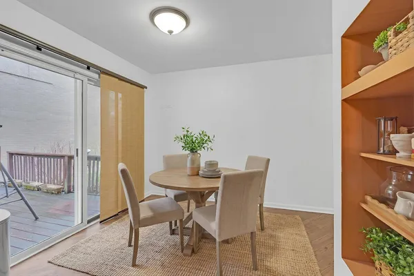 a view of a dining room with furniture and a potted plant