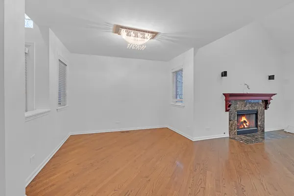 a view of a room with wooden floor and a ceiling fan