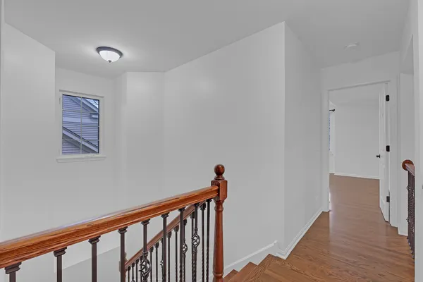 a view of hallway with wooden floor