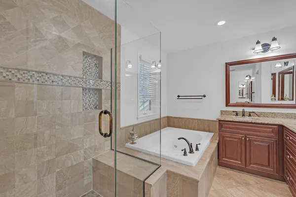 a bathroom with a sink a toilet a mirror and shower