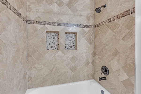 a bathroom with a bathtub and shower