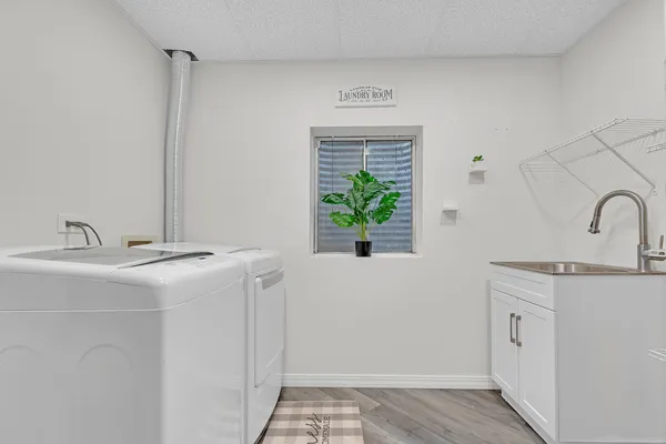 a utility room with cabinets washer and dryer