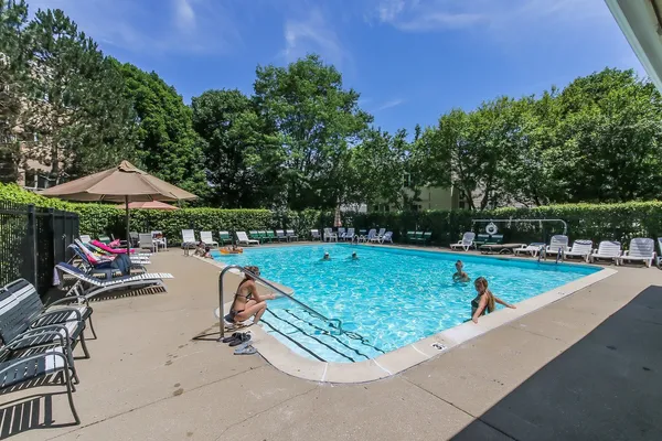 a view of swimming pool with sitting area and furniture