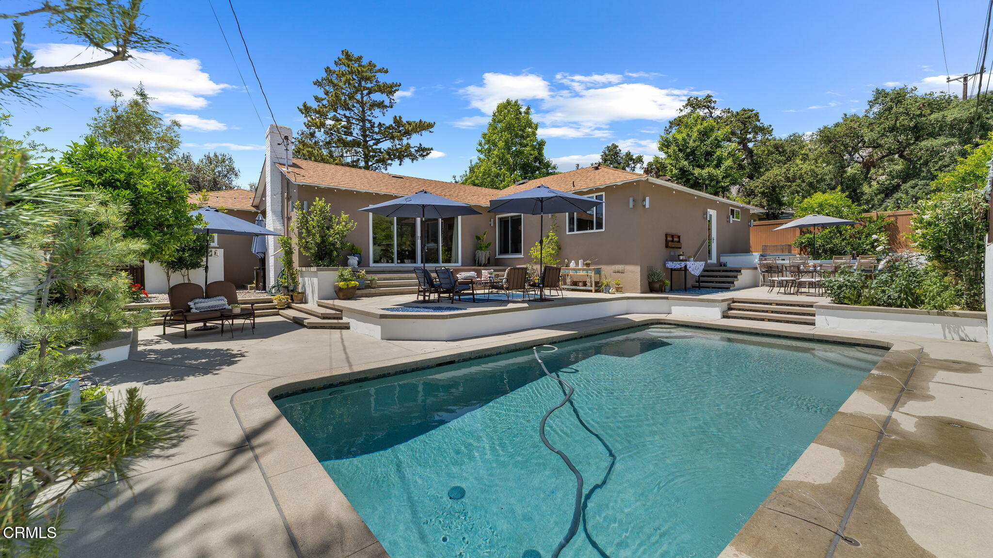 2030 North Altadena Drive Pasadena, CA 91107 - Photo 44 of 61 a patio with a table and chairs under an umbrella