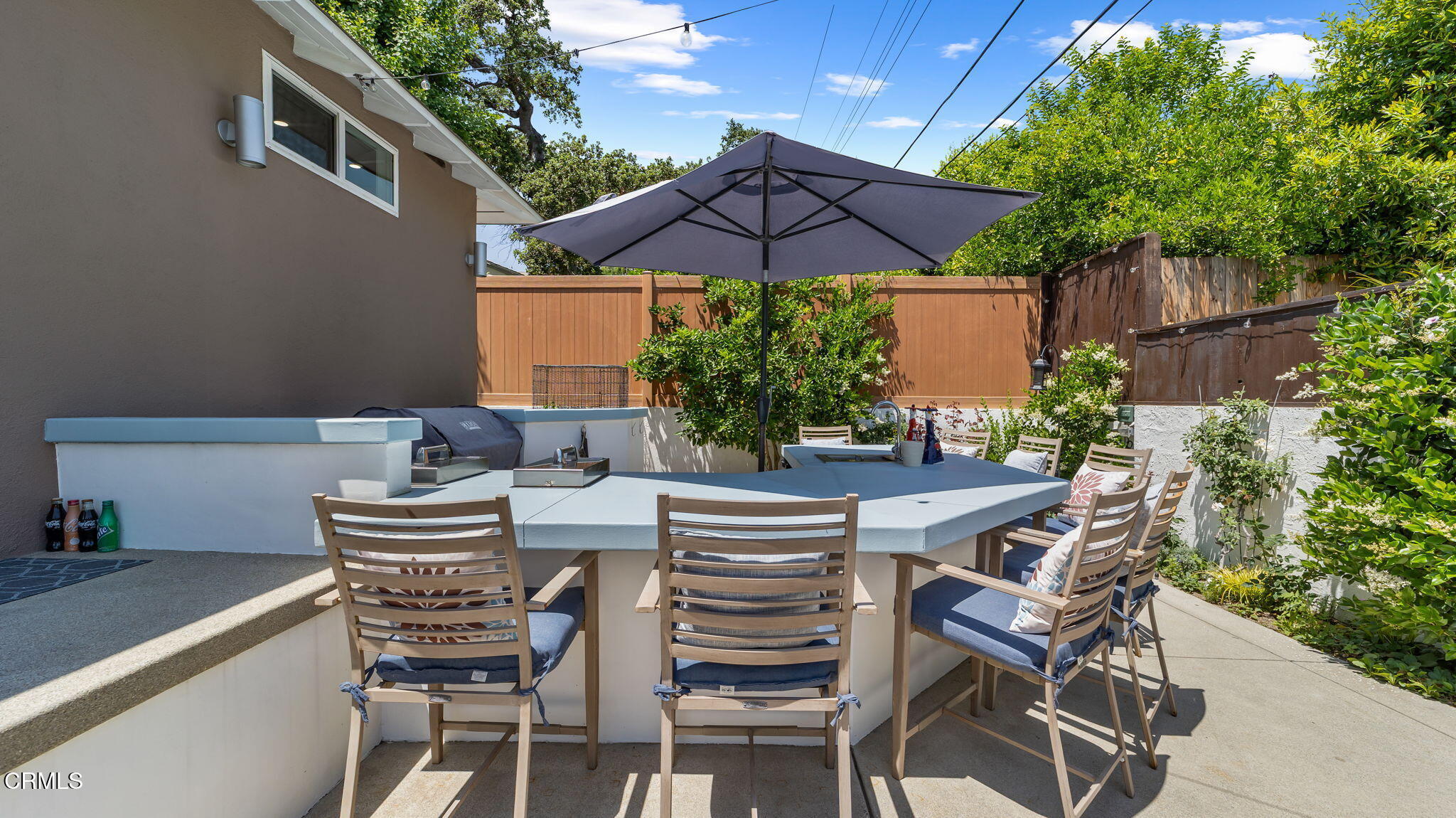 2030 North Altadena Drive Pasadena, CA 91107 - Photo 47 of 61 a patio with a table and chairs under an umbrella