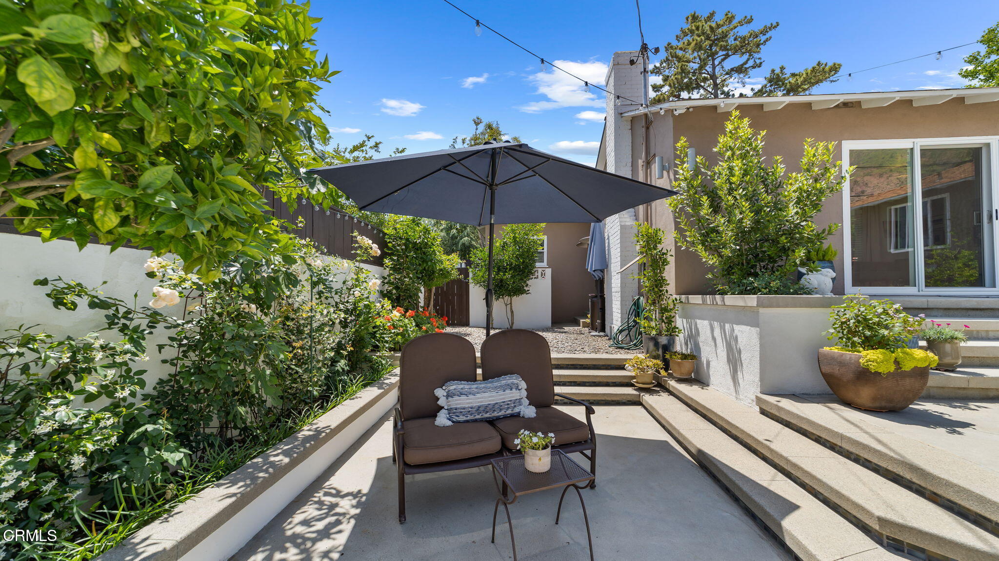 2030 North Altadena Drive Pasadena, CA 91107 - Photo 51 of 61 a view of a patio with couches table and chairs under an umbrella with potted plants
