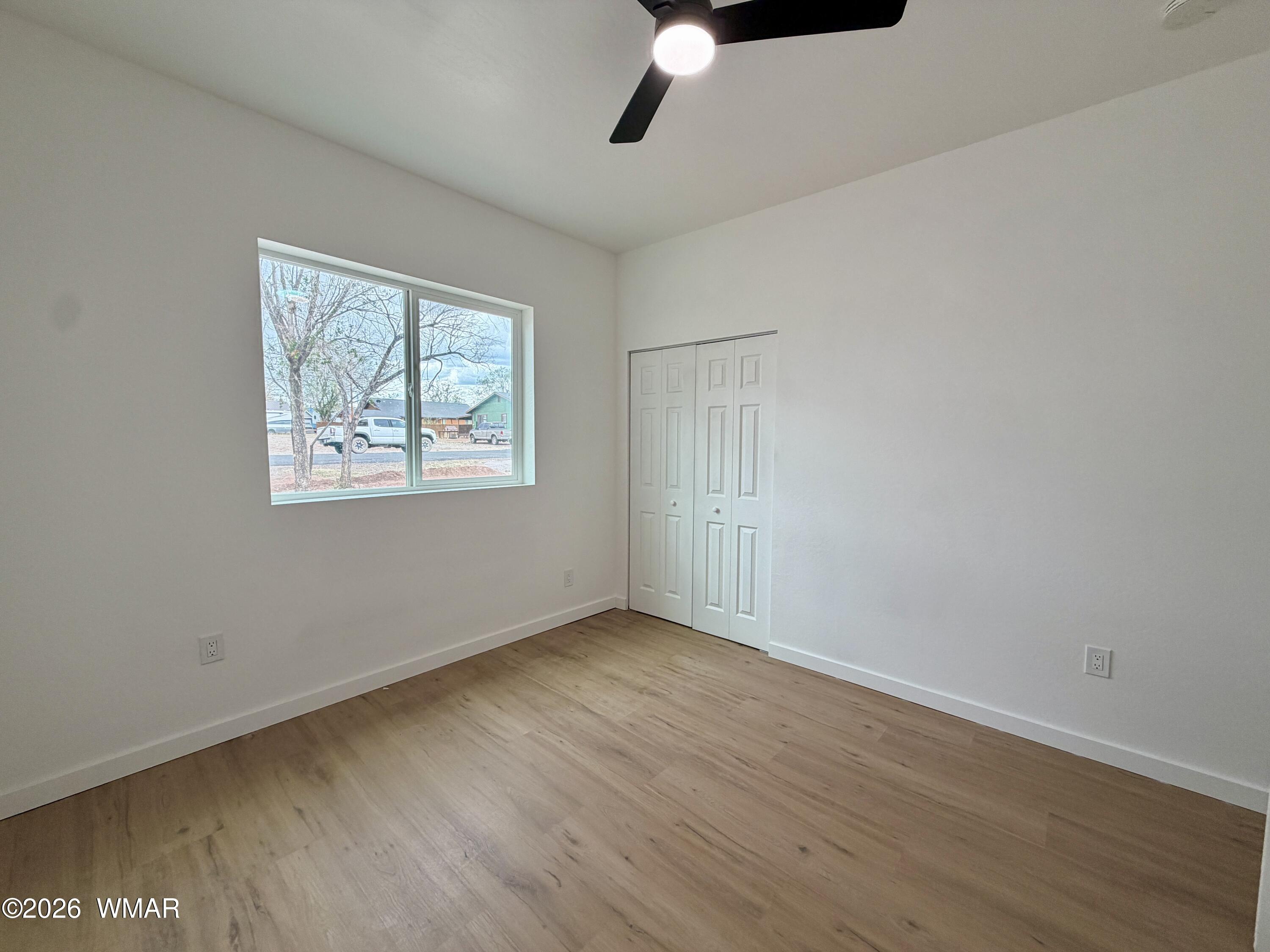 731 Tori Circle Springerville, AZ 85938 - Photo 14 of 19 a view of an empty room with wooden floor and a window