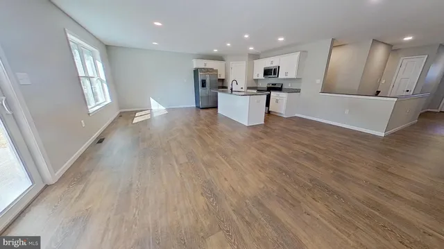 a view of kitchen with sink and refrigerator