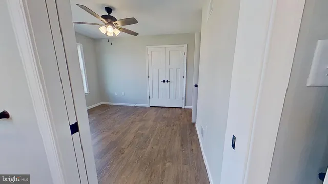 a view of a hallway with wooden floor