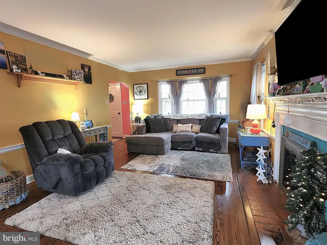 a living room with furniture flat screen tv and a fireplace