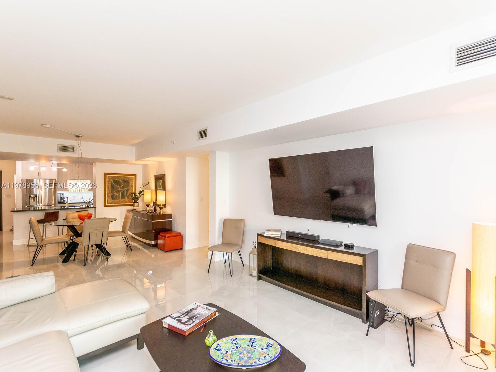 7350 Southwest 89th Street, Unit 719S Miami, FL 33156 - Photo 11 of 30 a living room with furniture and a flat screen tv