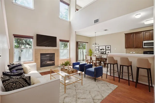 a living room with furniture a fireplace and a flat screen tv