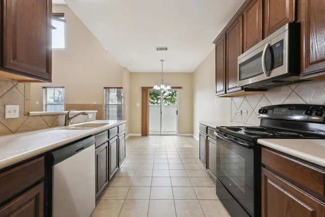 a kitchen with stainless steel appliances granite countertop a sink and cabinets