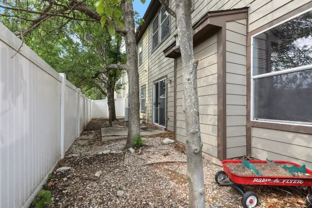 a view of a porch with a wooden door and a bench