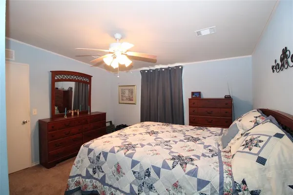a bedroom with a bed and a dresser