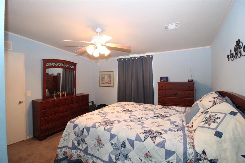 601 Carothers Avenue Rochester, TX 79544 - Photo 18 of 37 a bedroom with a bed and a dresser