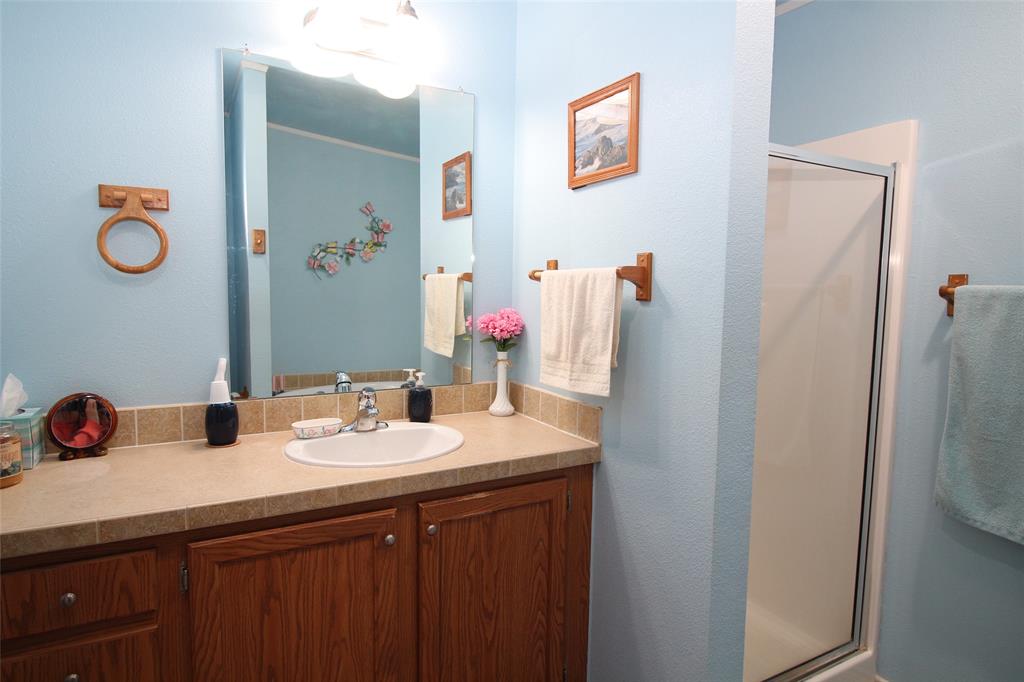 601 Carothers Avenue Rochester, TX 79544 - Photo 21 of 37 a bathroom with a sink and a mirror