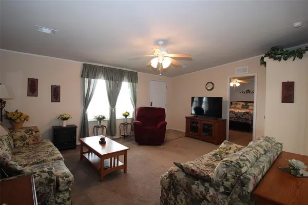 a living room with furniture fireplace and a large window