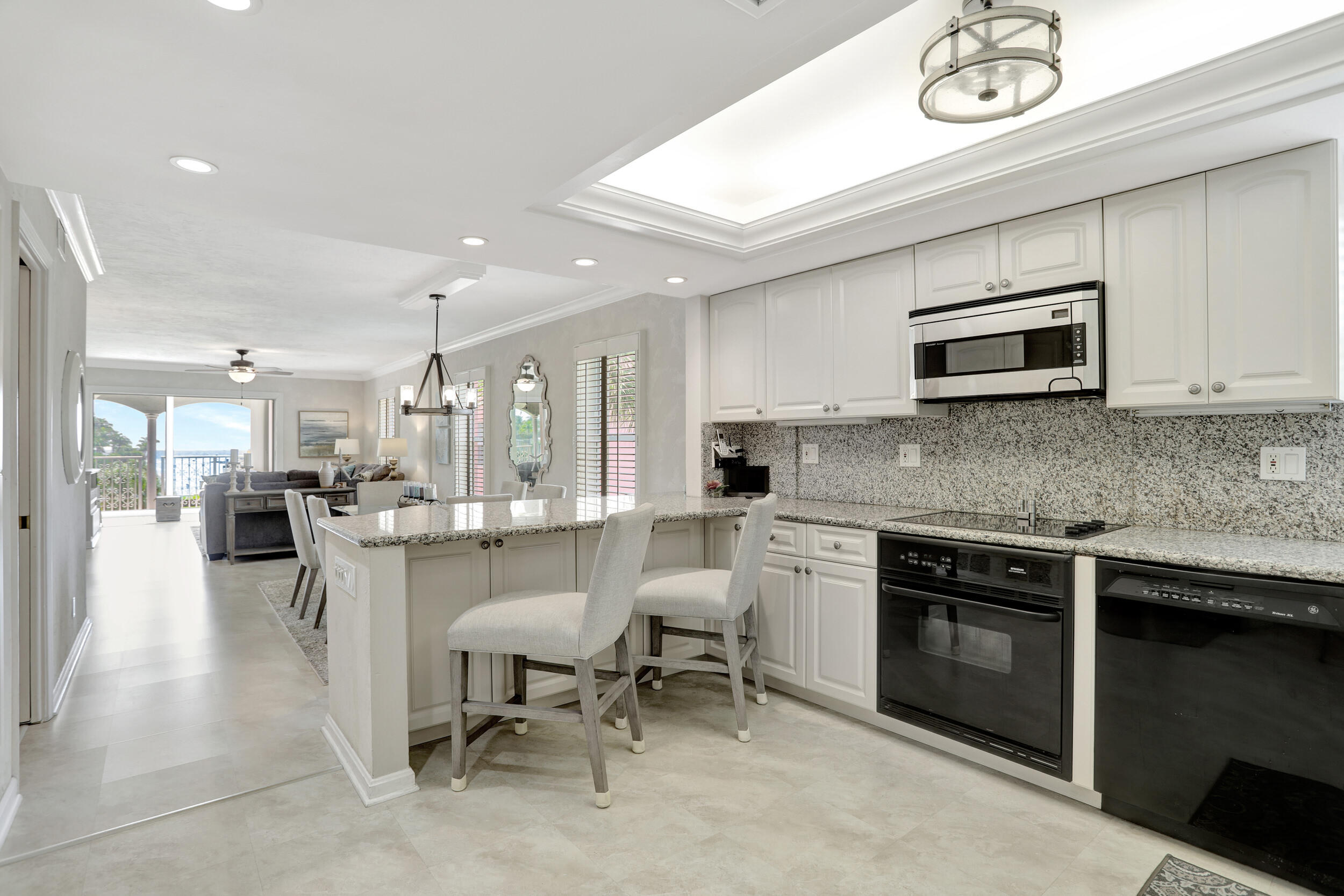 1040 Banyan Road, Unit 301C Boca Raton, FL 33432 - Photo 15 of 49 a kitchen with a sink and a stove top oven