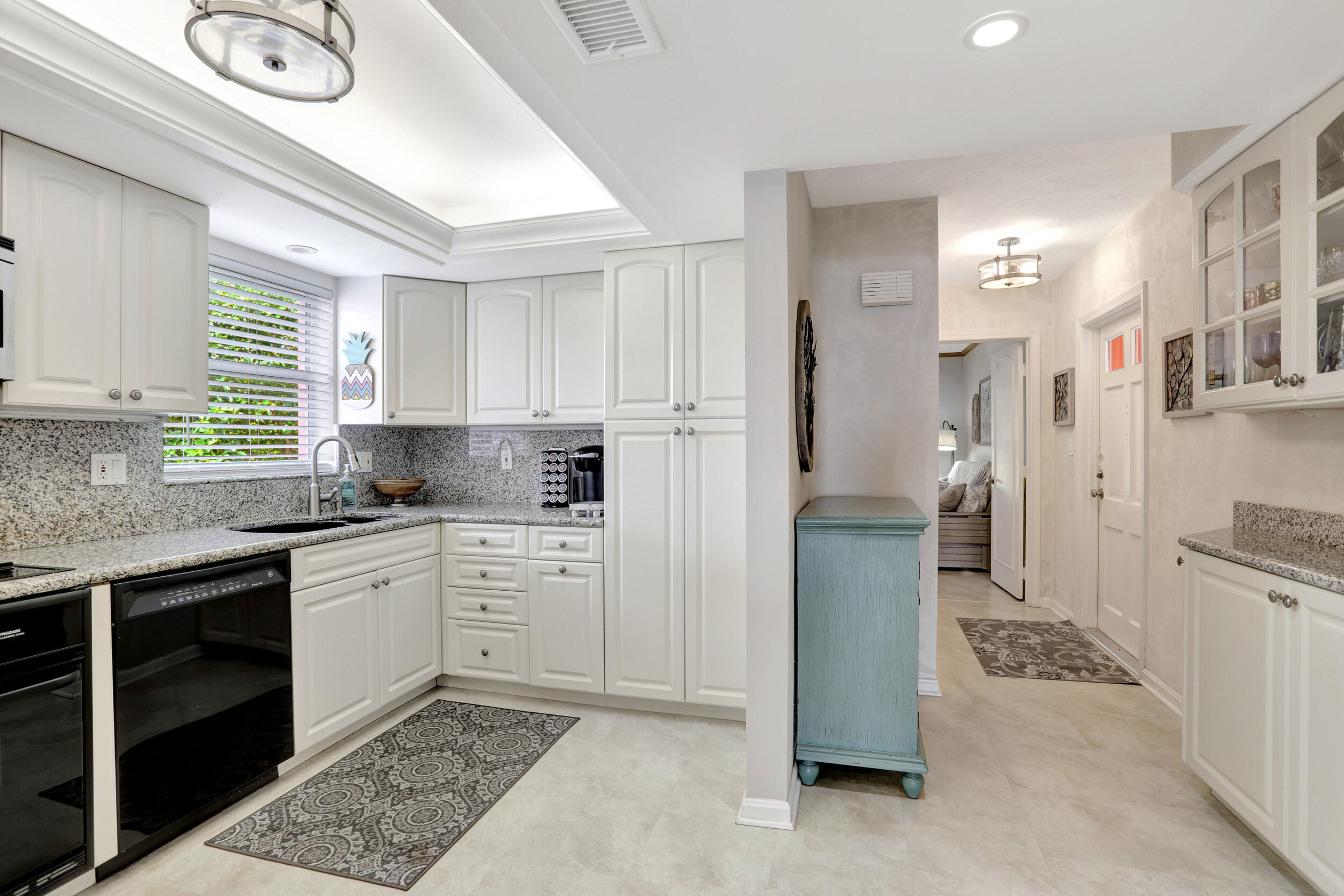 1040 Banyan Road, Unit 301C Boca Raton, FL 33432 - Photo 16 of 49 a kitchen with a refrigerator and a sink