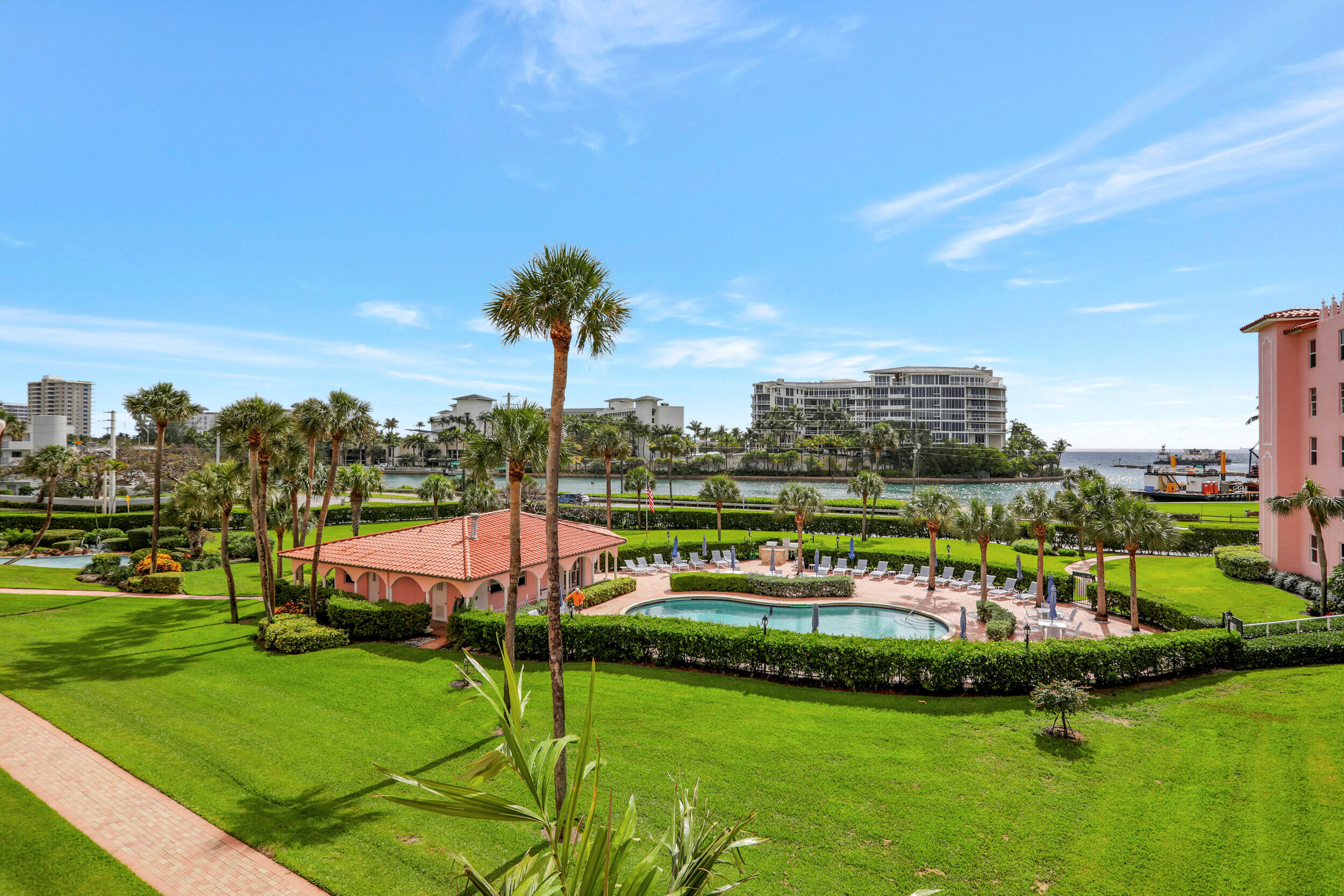 1040 Banyan Road, Unit 301C Boca Raton, FL 33432 - Photo 2 of 49 a view of a swimming pool with a yard and lake view