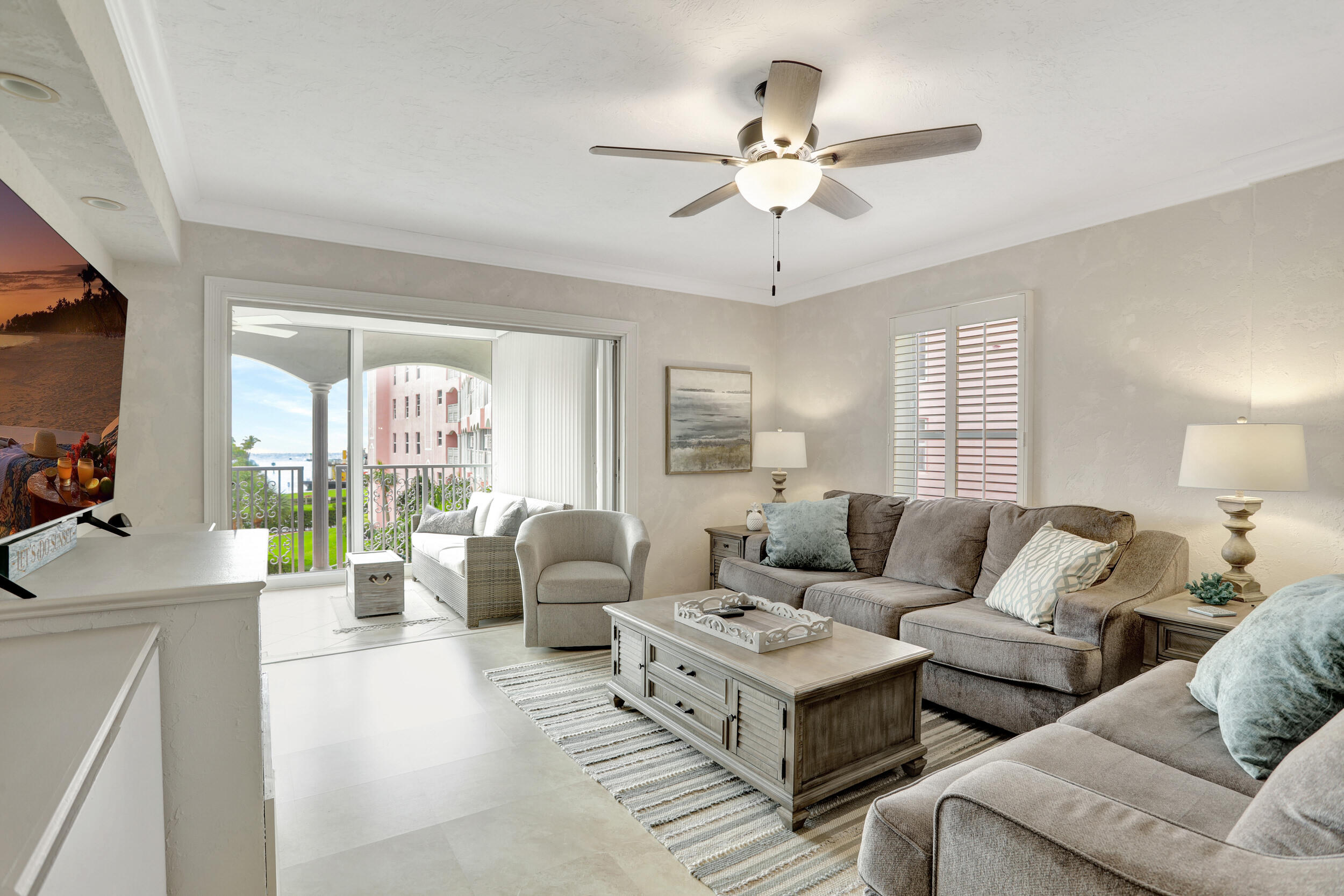 1040 Banyan Road, Unit 301C Boca Raton, FL 33432 - Photo 21 of 49 a living room with furniture and a flat screen tv