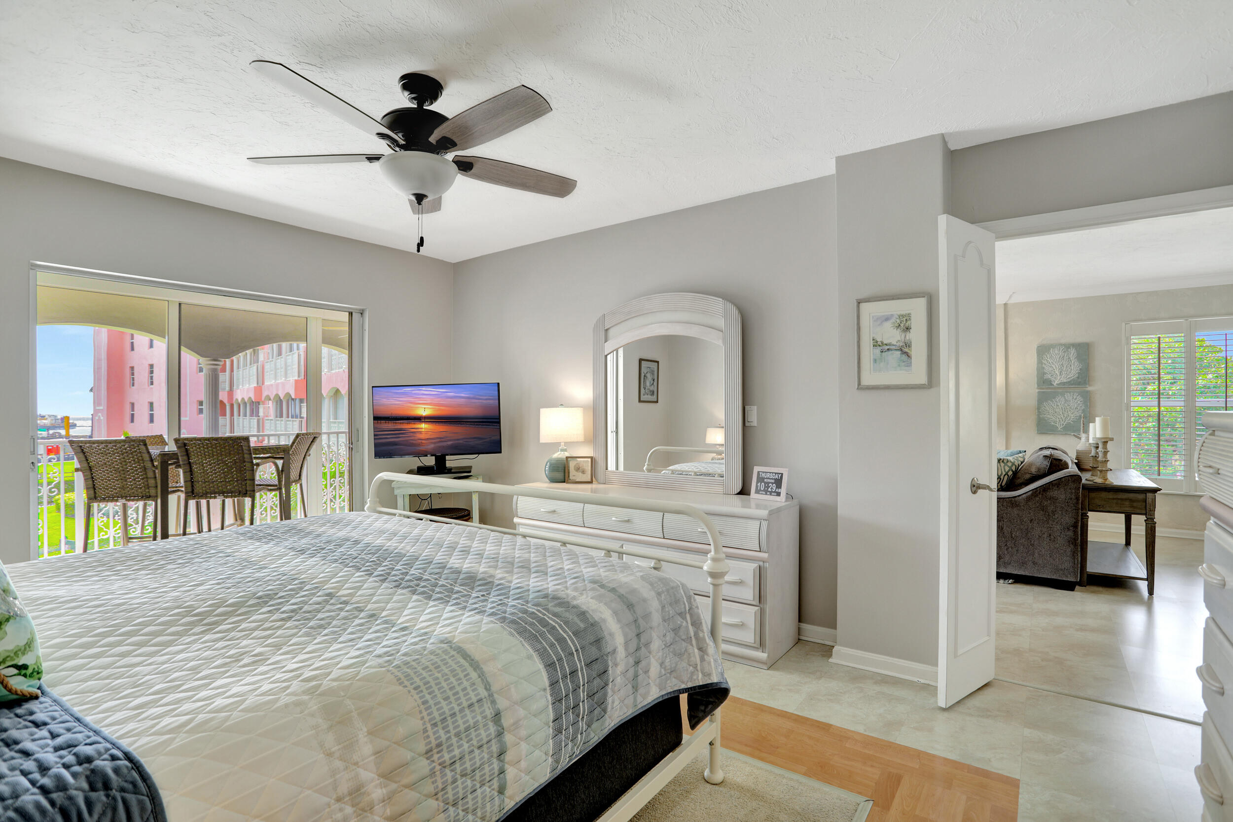 1040 Banyan Road, Unit 301C Boca Raton, FL 33432 - Photo 29 of 49 a bedroom with a bed a large window and couch