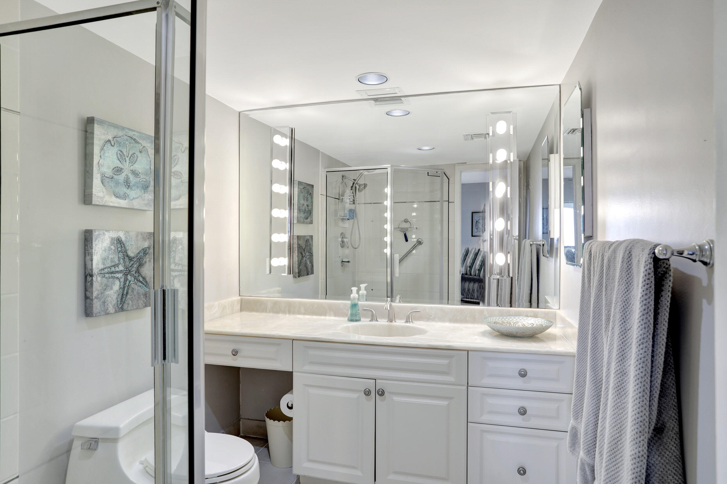 1040 Banyan Road, Unit 301C Boca Raton, FL 33432 - Photo 30 of 49 a bathroom with a double vanity sink toilet and shower