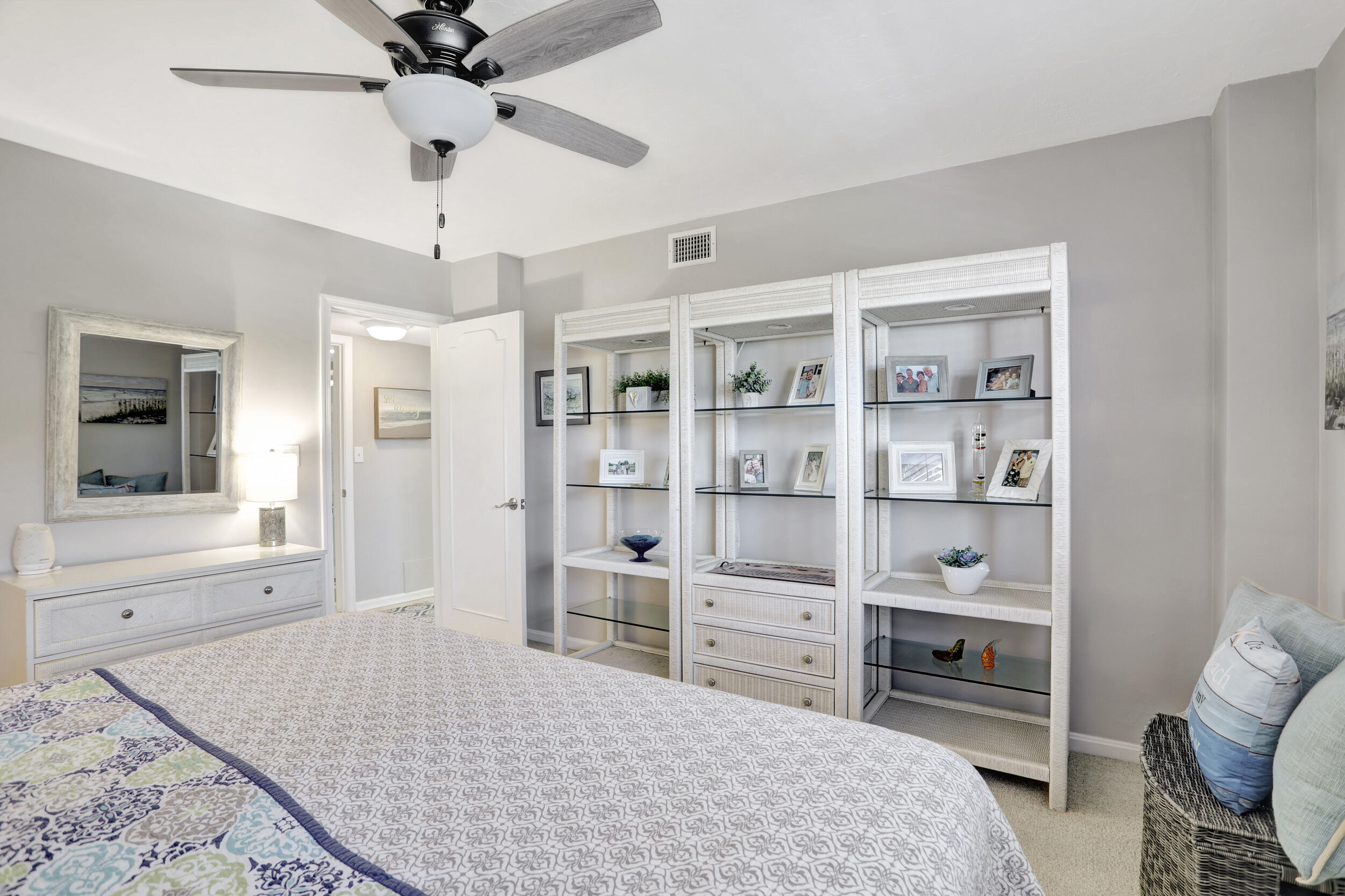 1040 Banyan Road, Unit 301C Boca Raton, FL 33432 - Photo 33 of 49 a bedroom with a bed and a book shelf