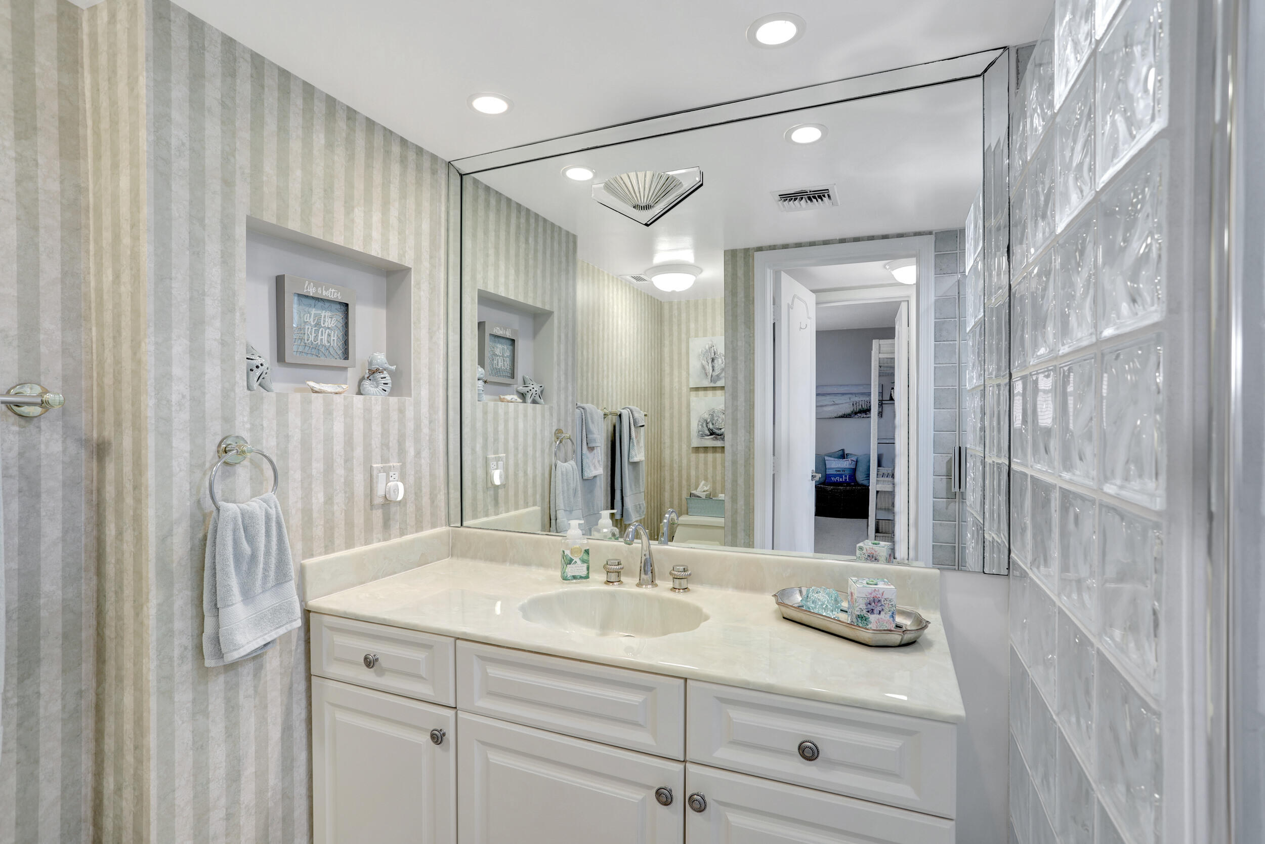 1040 Banyan Road, Unit 301C Boca Raton, FL 33432 - Photo 35 of 49 a bathroom with a sink double vanity and a mirror