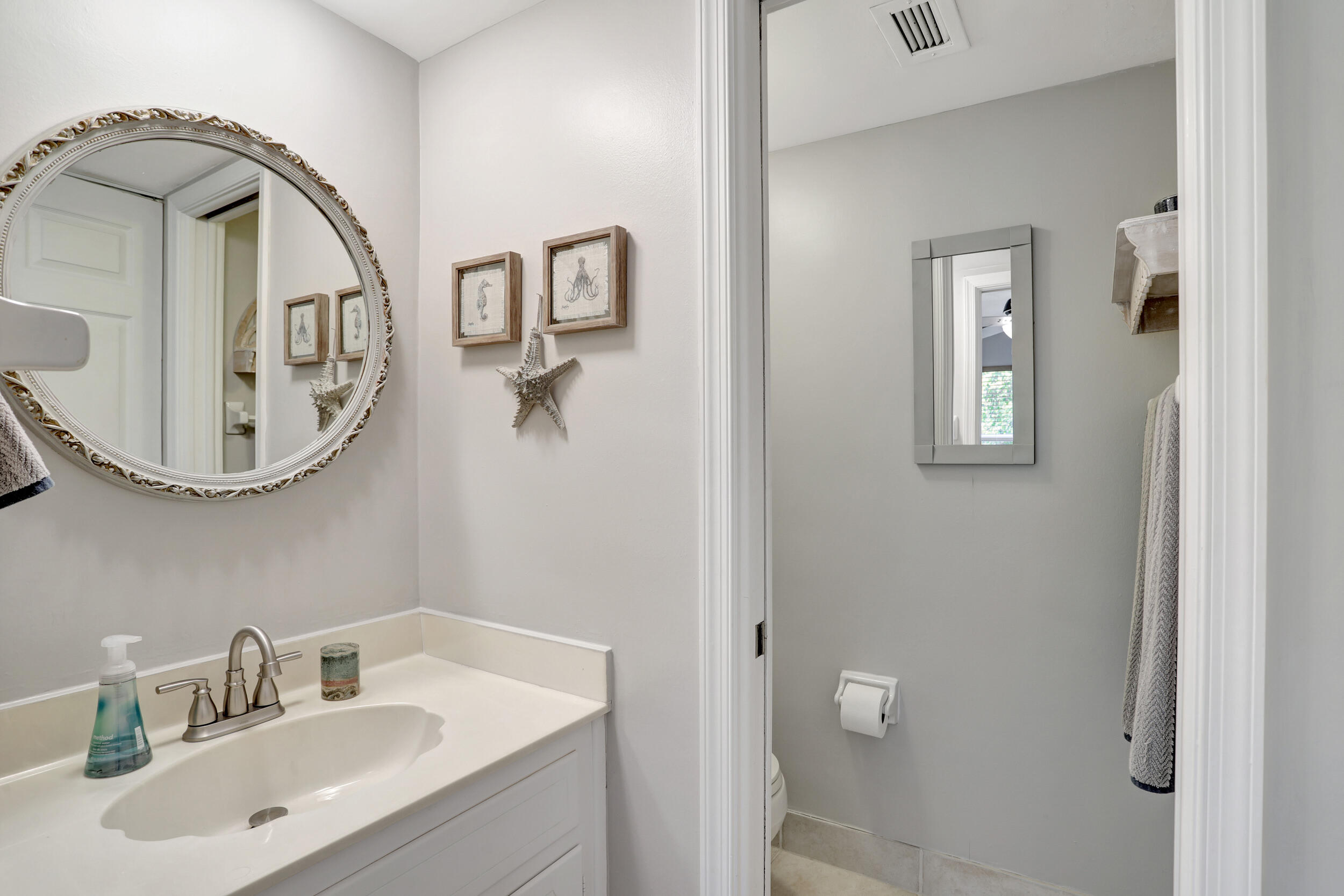 1040 Banyan Road, Unit 301C Boca Raton, FL 33432 - Photo 38 of 49 a bathroom with a sink and a mirror