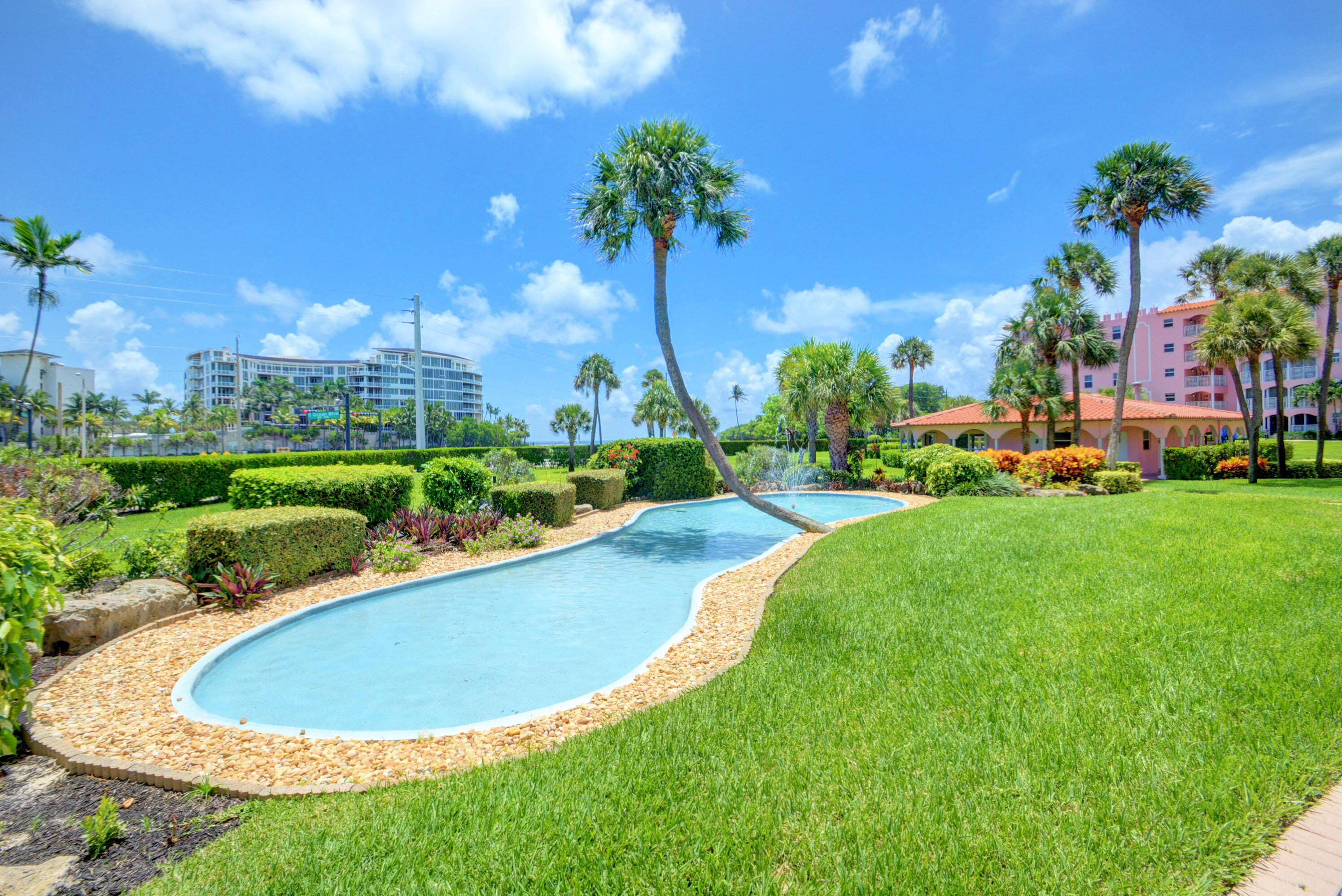 1040 Banyan Road, Unit 301C Boca Raton, FL 33432 - Photo 45 of 49 a view of a swimming pool and a yard