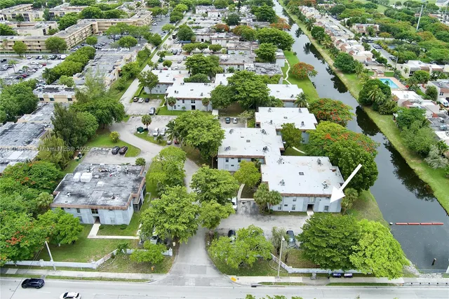 an aerial view of residential houses with outdoor space and street view