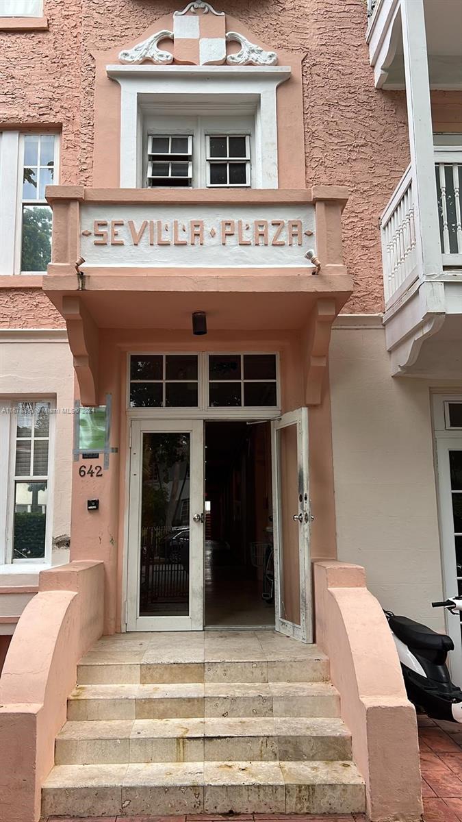 642 Michigan Avenue, Unit 29 Miami Beach, FL 33139 - Photo 4 of 12 a view of a building with a balcony and large windows