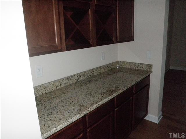 4854 Inwood Road Raleigh, NC 27603 - Photo 5 of 20 Handy butlers pantry from the dining to the kitchen with granite counters