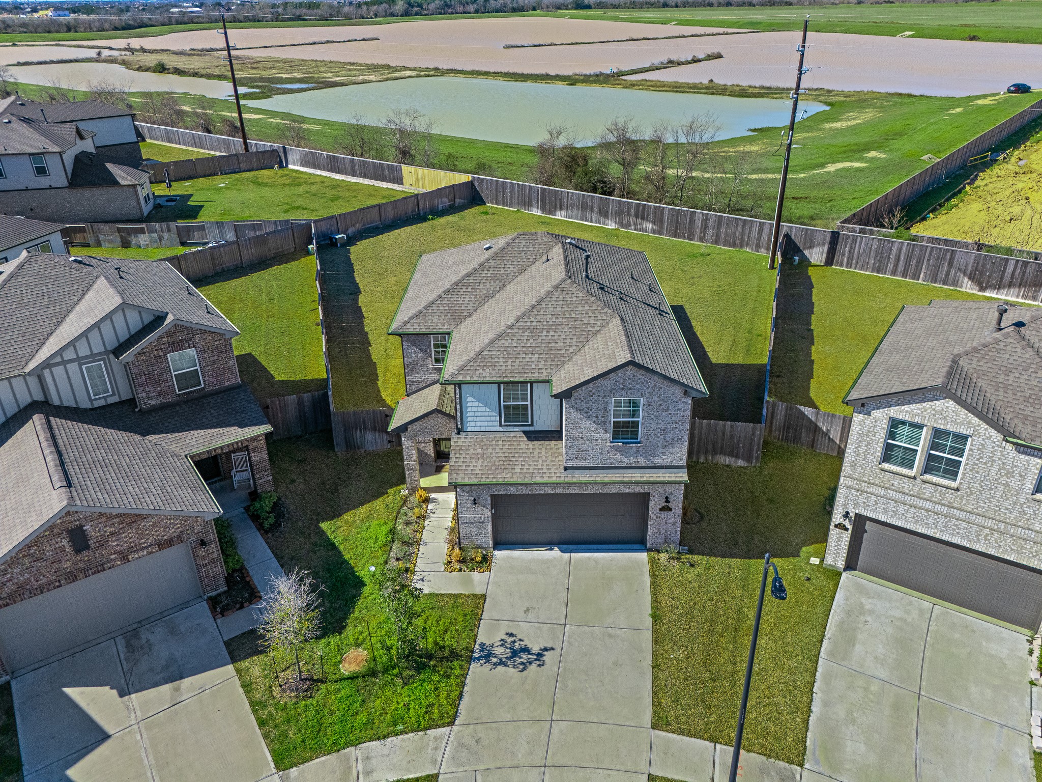 an aerial view of a house with pool and porch