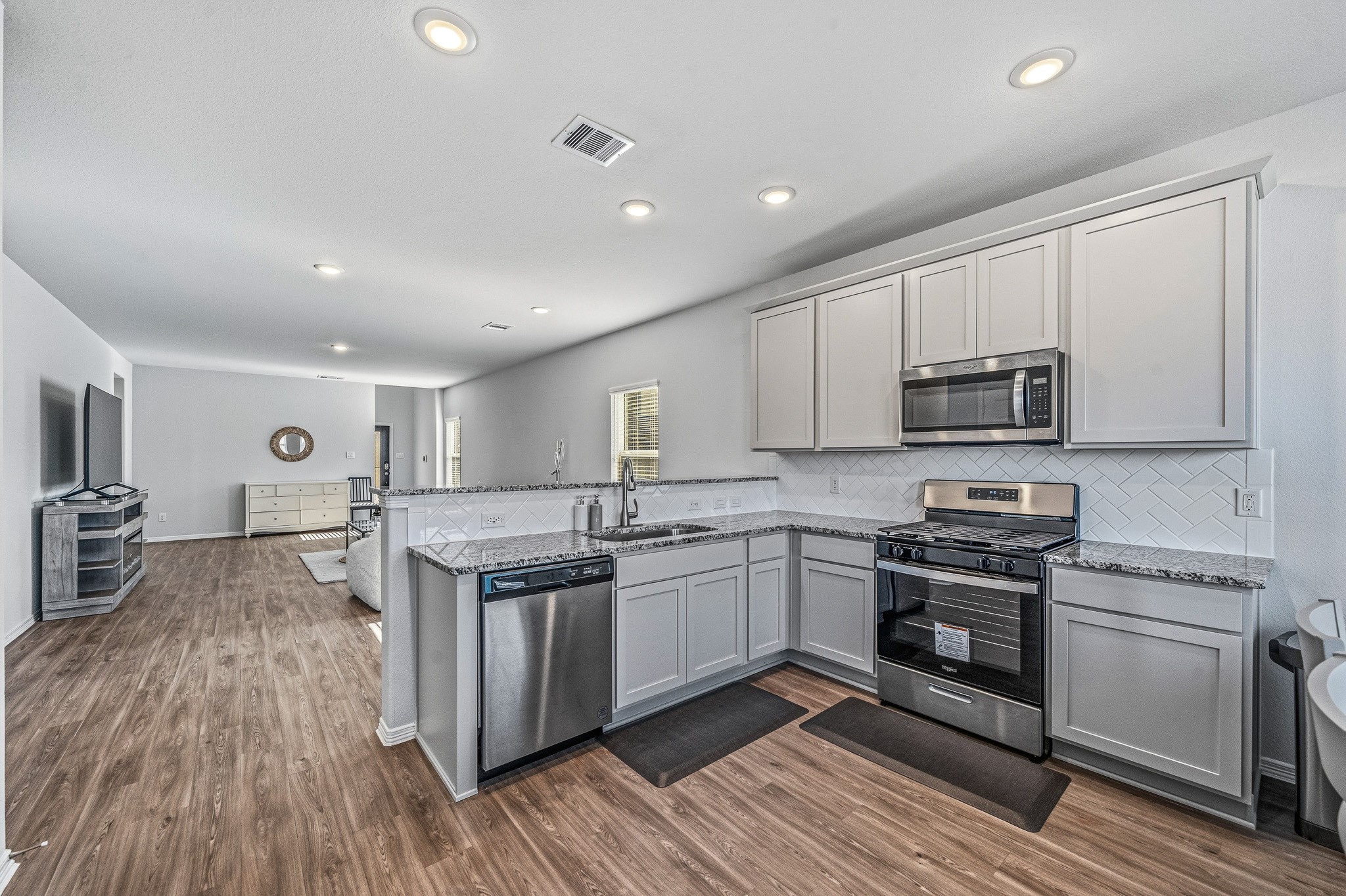 5903 Dawning Sun Road Katy, TX 77493 - Photo 13 of 37 a kitchen with stainless steel appliances granite countertop a stove and a sink