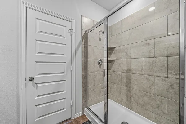 a view of walk in closet with empty racks