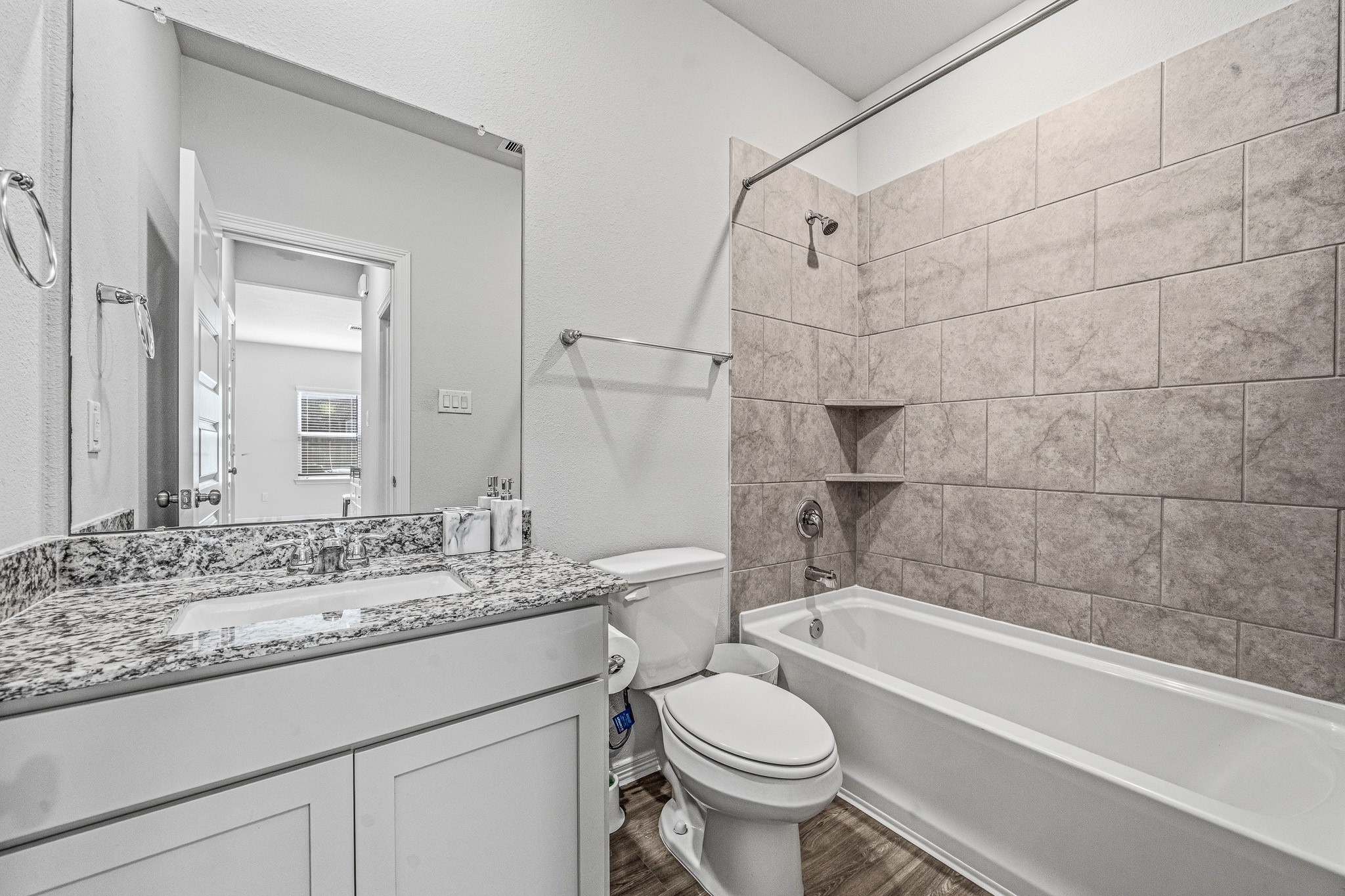 5903 Dawning Sun Road Katy, TX 77493 - Photo 21 of 37 a bathroom with a granite countertop sink toilet mirror and bathtub