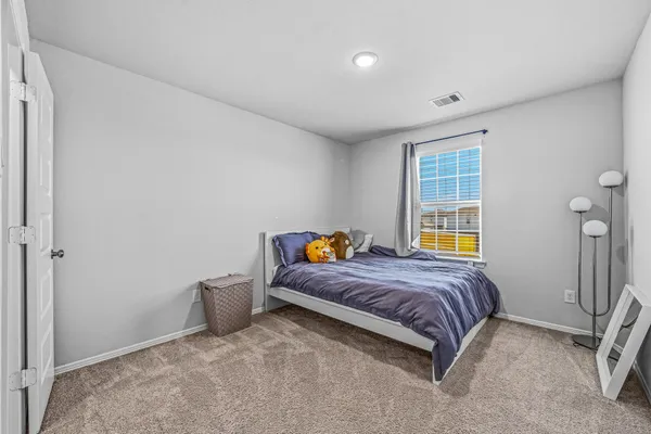 a bedroom with a bed and chair