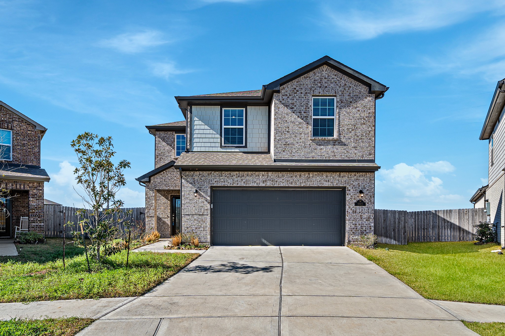5903 Dawning Sun Road Katy, TX 77493 - Photo 5 of 37 a front view of a house with a yard and garage