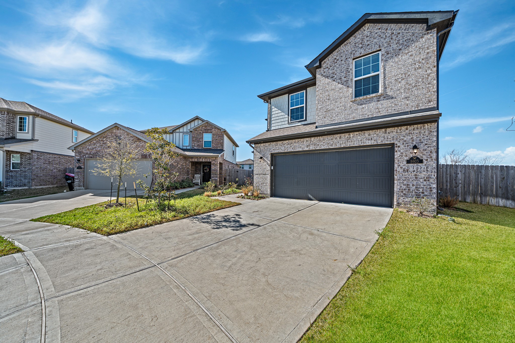 5903 Dawning Sun Road Katy, TX 77493 - Photo 6 of 37 a front view of a house with a yard and garage