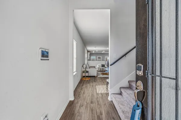 a view of entryway with wooden floor and stairs
