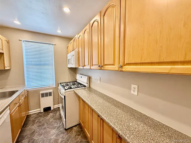 a kitchen with a sink a stove and cabinets