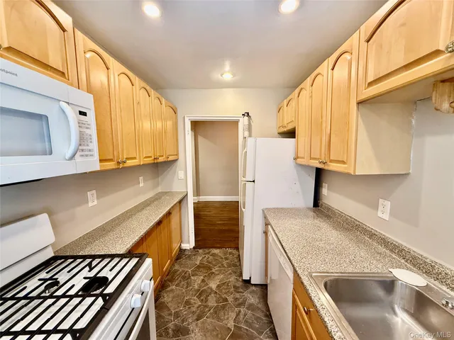 a kitchen with stainless steel appliances granite countertop a sink and a stove
