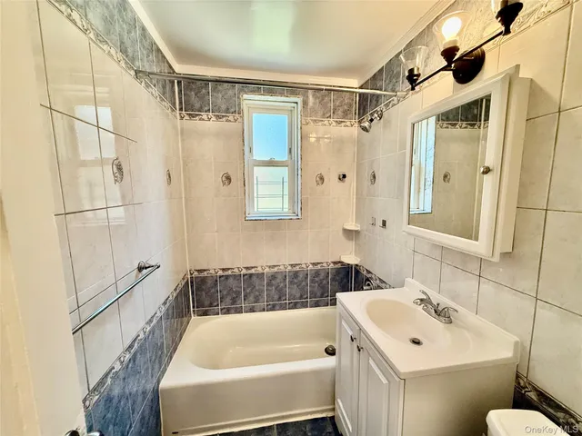 a bathroom with a tub a sink and a shower