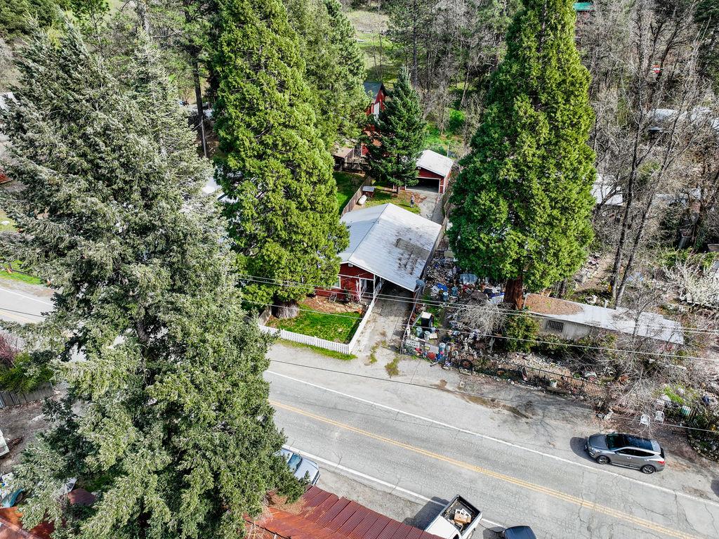 an aerial view of a house with a yard basket ball court and outdoor seating