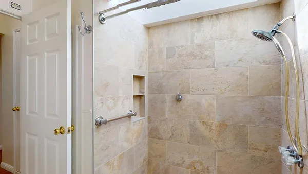 a view of a room with rack on the wall and a window