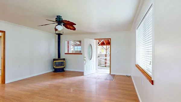 wooden floor in an empty room with a window